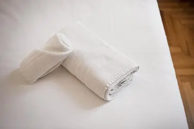 a white towel sitting on top of a bed at Trevi Fountain Apartment in Rome