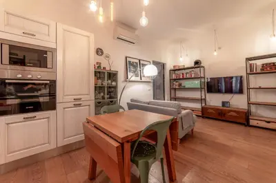 a living room with a table and a couch at Casa Gioia - Metro Garbatella in Rome