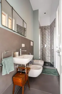 a bathroom with a white sink and a toilet at La finestra verde in Rome