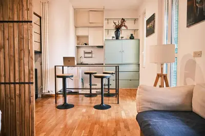 a living room with a glass table and stools at Terrazza San Saba in Rome