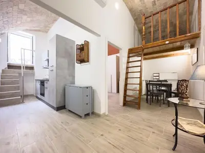 a kitchen and a dining room with a loft at Apartment with Terrace in the Heart of Pigneto in Rome