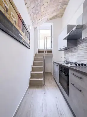 a kitchen with a staircase leading up to a window at Apartment with Terrace in the Heart of Pigneto in Rome