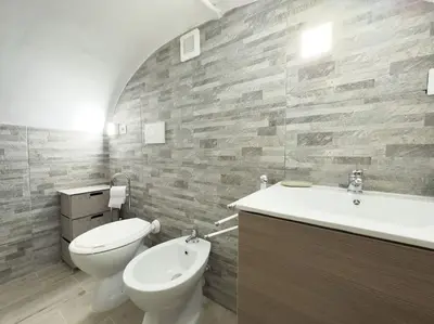 a bathroom with a white toilet and a sink at Apartment with Terrace in the Heart of Pigneto in Rome