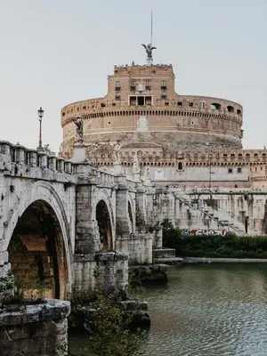 a bridge over a river with a building at Maison Carlotta In Vatican in Rome