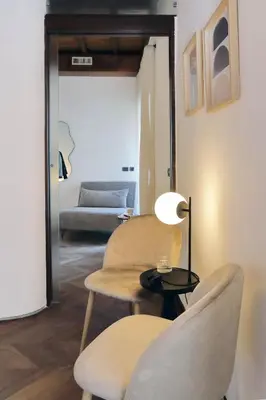a living room with two chairs and a table and a couch at YCH Elegant flat with terrace to Trastevere in Rome