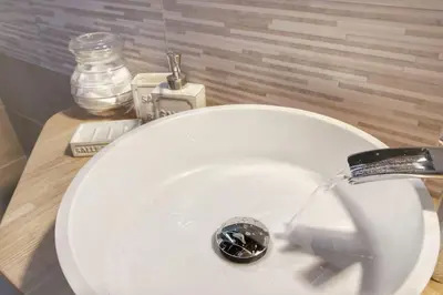 a white sink with water coming out of a faucet at Hidden Treasure-Campo de' Fiori in Rome