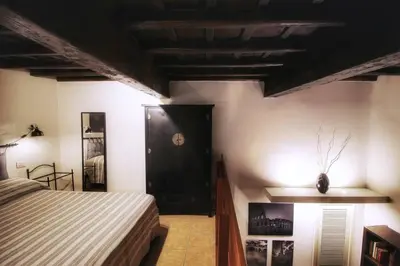 a bedroom with a bed and a black door at Hidden Treasure-Campo de' Fiori in Rome