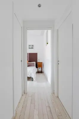 a white hallway with a bed in a bedroom at Minerva's Place in Rome