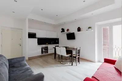 a living room with a couch and a dining room table at Minerva's Place in Rome