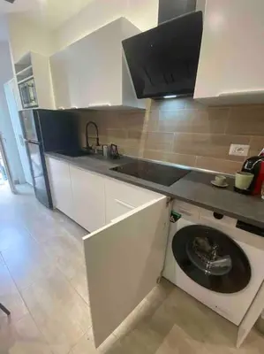 a kitchen with a sink and a plate in a dishwasher at La Casa di Marco Polo in Rome