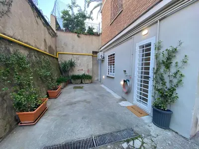 an alley with plants in pots next to a building at La Casa di Marco Polo in Rome