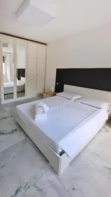 a large white bed in a white bedroom at Vignola New Apartment in Rome