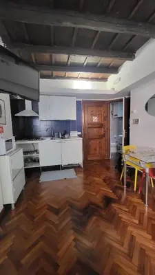 a kitchen with a wooden floor and a table at Vivaldi in Rome