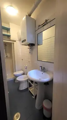 a bathroom with two toilets and a sink and a mirror at Vivaldi in Rome