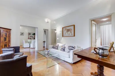 a living room with a white couch and a table at Pantheon Exclusive House in Rome