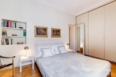 a white bedroom with a bed and a desk at Pantheon Exclusive House in Rome