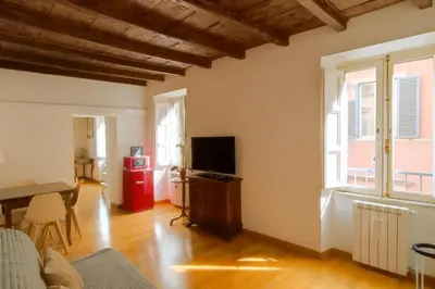 a living room with a television and a table at San Martino Home in Rome