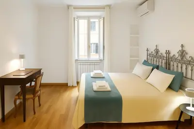 a bedroom with a bed and a desk and a table at San Martino Home in Rome