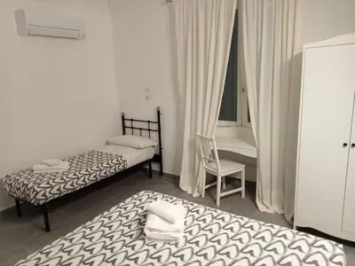 a small bedroom with two beds and a chair at Air Vatican in Rome