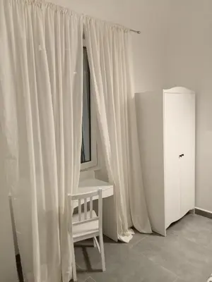 a white room with a chair and a window at Air Vatican in Rome