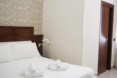 a bedroom with a bed with two candles on it at Monti 66 Hotel in Rome