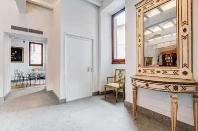 a mirror on a wall in a room with a table at BMGA l Luxury Home with Patio in Trastevere in Rome