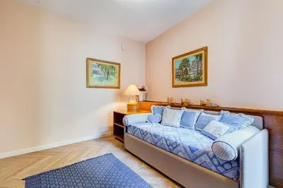 a bedroom with a bed with blue pillows at BMGA l Luxury Home with Patio in Trastevere in Rome