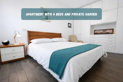 a bedroom with a bed with a green and white blanket at 15 MIN FROM THE VATICAN Wi-fi and garden in Rome