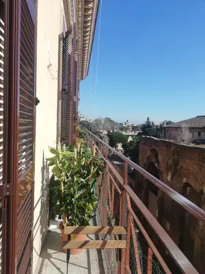 a balcony with a bench and a plant at Aria Rome Rooms in Rome
