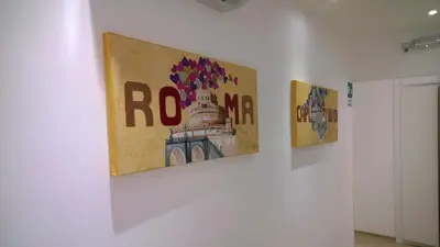 three pieces of art on a wall in a room at Buonarroti Guest House in Rome