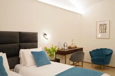 a bedroom with a bed and a desk and a chair at Charm&Bella GuestHouse in Rome