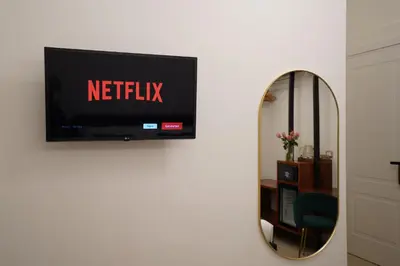 a television with the netflix sign on a wall at Charm&Bella GuestHouse in Rome