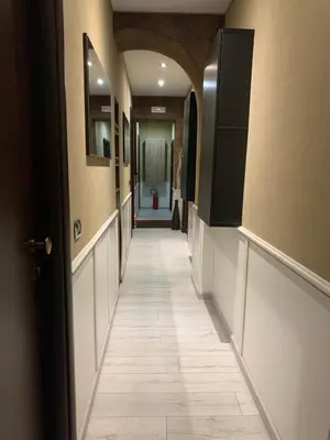 a hallway with a tile floor in a building at Blue Suite Vatican Guesthouse in Rome