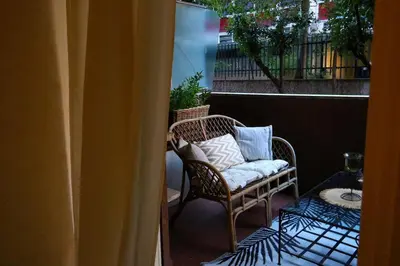 a wicker chair with pillows sitting on a balcony at Inn Trastevere in Rome