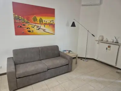 a living room with a couch and a painting on the wall at Inn Trastevere in Rome