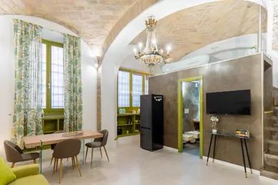 a living room with a couch and a dining room at LOFT49 in Rome