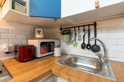 a kitchen with a sink and a microwave at Rhome_Hub in Rome