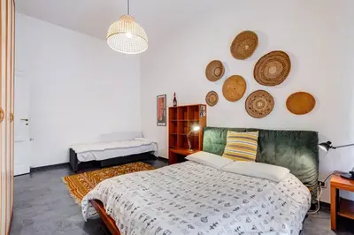 a bedroom with a bed and some baskets on the wall at Termini Sweet Home in Rome