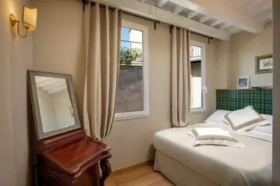 a bedroom with two beds and a mirror and window at Daplace - Arianna Apartment in Rome