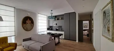 a living room with a couch and a chair and a table at A casa di Marisa in Rome