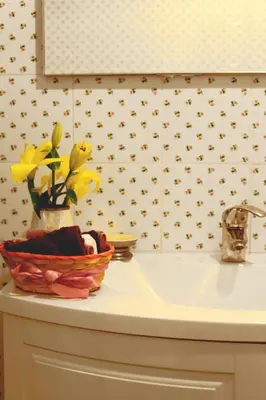 a bathroom sink with a basket of flowers on it at Bed and Breakfast Piazza Vittorio87 in Rome