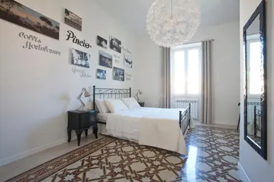 a bedroom with a bed and a chandelier at Saint Peter's Keys in Rome
