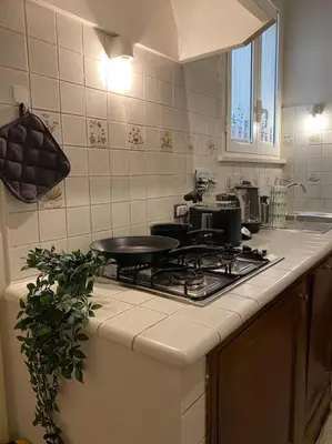 a kitchen with a stove with a pan on it at CasAlice Apartment Trastevere in Rome