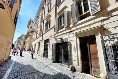 a street with people walking down a cobblestone street at Leonina4 Cozy Apartment in Rome