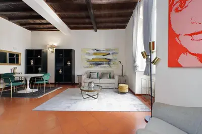 a living room with a table and a couch at Leonina4 Cozy Apartment in Rome