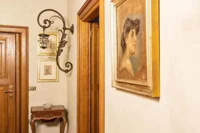 a painting of a woman on a wall next to a door at iFlat Golden Gem in Trevi in Rome