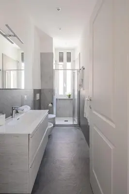 a white bathroom with a sink and a toilet at Lunaria Apartment Vatican Rome in Rome