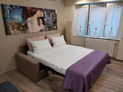 a bedroom with a large bed and a couch at Casa Sorelle Marchisio in Rome
