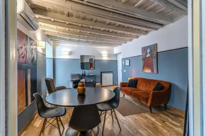 a living room with a table and chairs and a couch at Appartamento centro storico BACCINAHOME in Rome