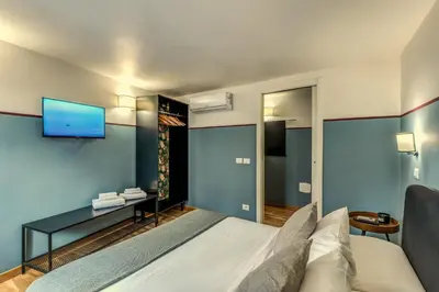 a bedroom with a bed and a tv on the wall at Appartamento centro storico BACCINAHOME in Rome
